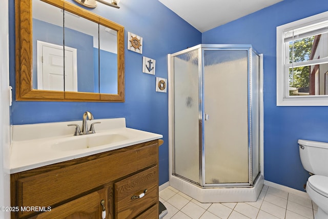 full bathroom featuring toilet, baseboards, a shower stall, vanity, and tile patterned floors