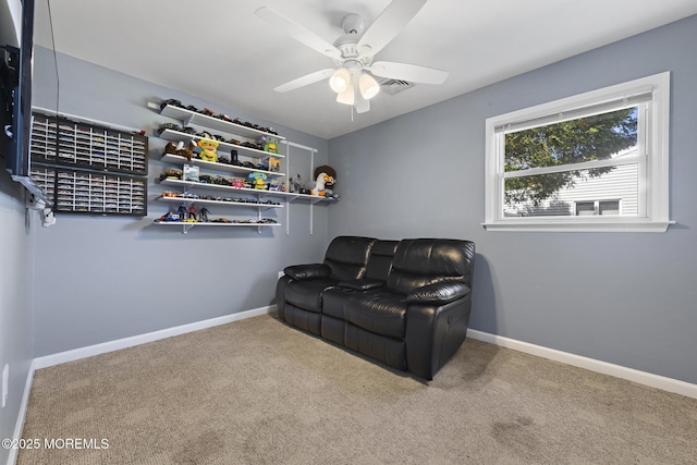 living area with ceiling fan, carpet floors, and baseboards