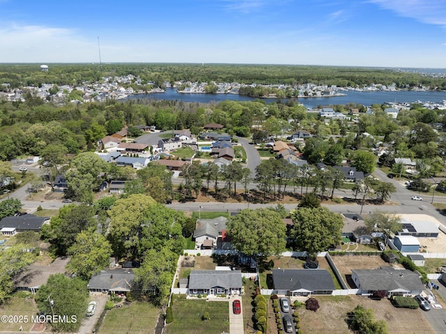 aerial view of property and surrounding area with a large body of water and nearby suburban area