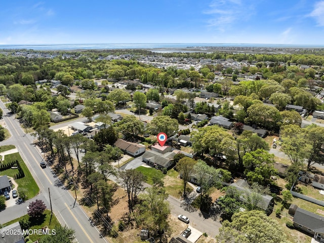 aerial view of property and surrounding area featuring nearby suburban area