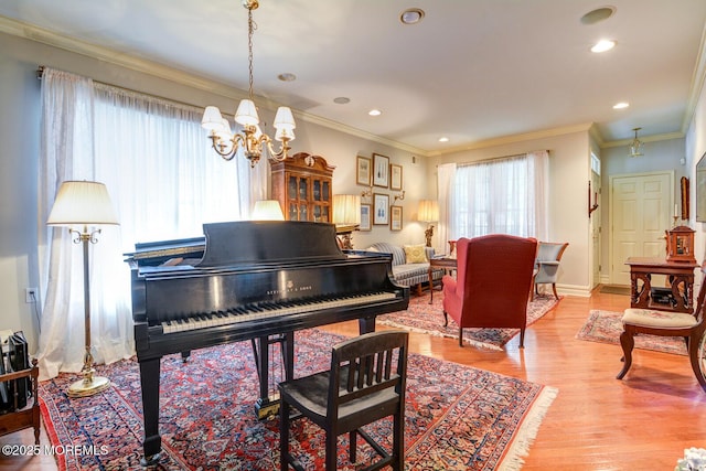 living area with a chandelier, light wood-style floors, ornamental molding, and recessed lighting