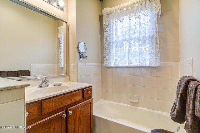 bathroom featuring a tub to relax in and vanity