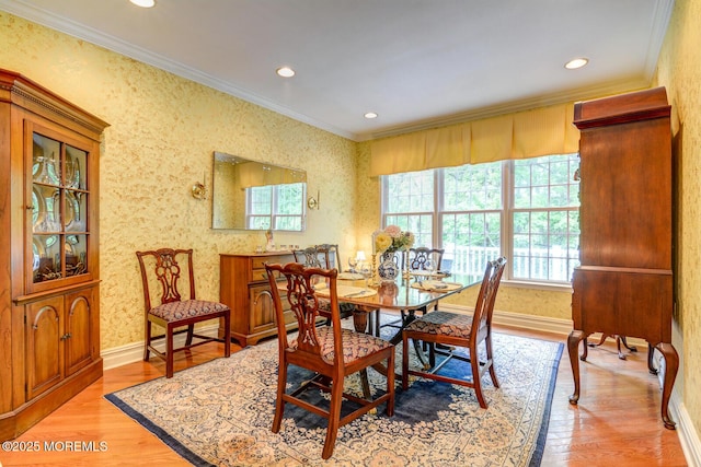 dining space featuring ornamental molding, plenty of natural light, light wood-type flooring, baseboards, and recessed lighting