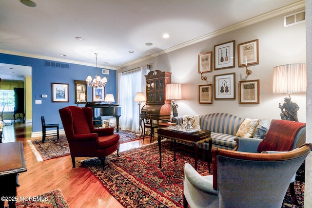 living area featuring a chandelier, wood finished floors, crown molding, recessed lighting, and baseboards