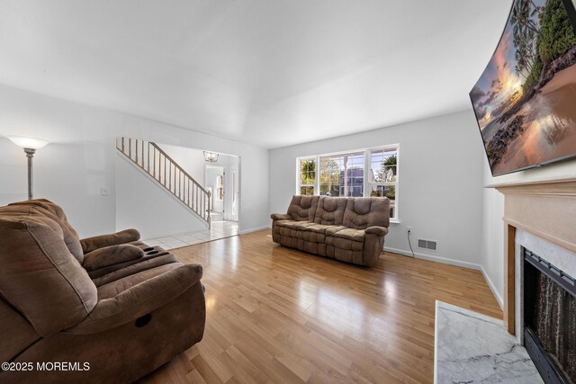 316 Nautilus Dr, Manahawkin, NJ 08050 - living area featuring a fireplace, stairway, wood finished floors, and baseboards
