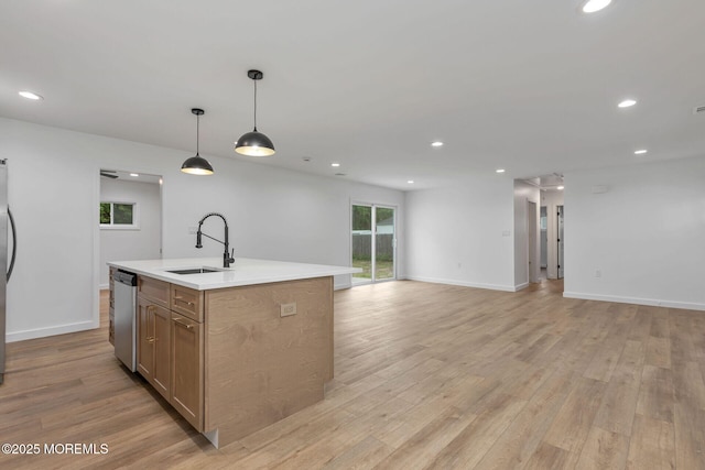 kitchen featuring a sink, dishwasher, light wood-style flooring, recessed lighting, and open floor plan