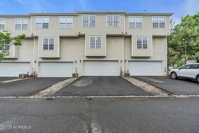 3 Kuczynski Dr Unit 944, Parlin, NJ 08859 - view of property featuring a garage, driveway, and central air condition unit