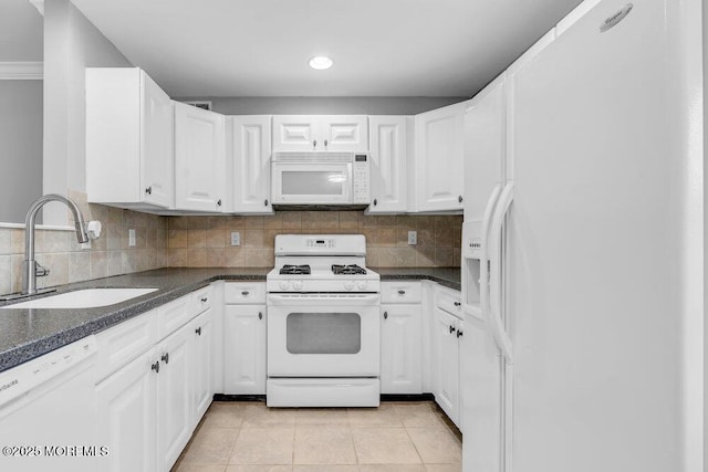 3 Kuczynski Dr Unit 944, Parlin, NJ 08859 - kitchen with white appliances, a sink, dark countertops, white cabinets, and light tile patterned floors