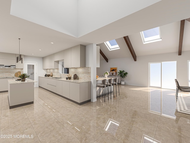 kitchen featuring backsplash, modern cabinets, a skylight, beam ceiling, and a sink
