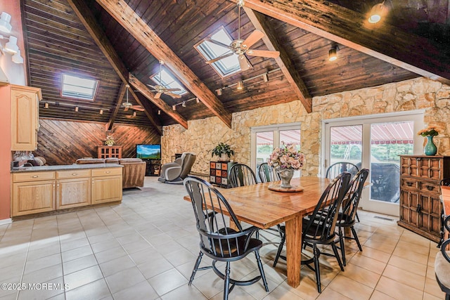 dining space with wooden ceiling, a skylight, high vaulted ceiling, light tile patterned floors, and beam ceiling