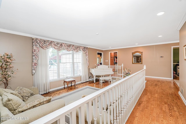 living room with baseboards, recessed lighting, ornamental molding, and light wood-type flooring