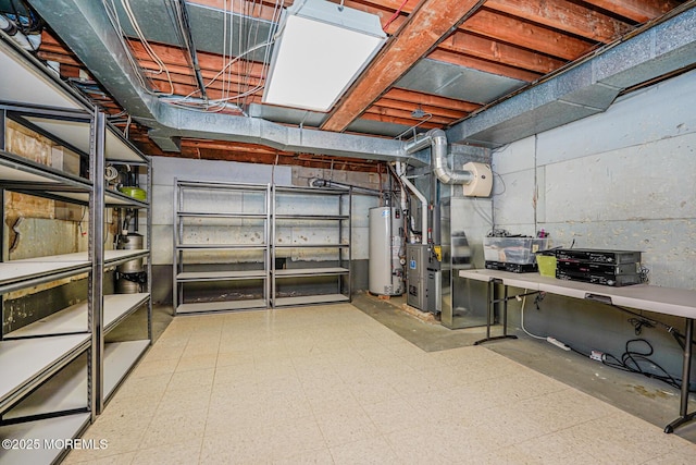 unfinished basement with gas water heater, tile patterned floors, and heating unit
