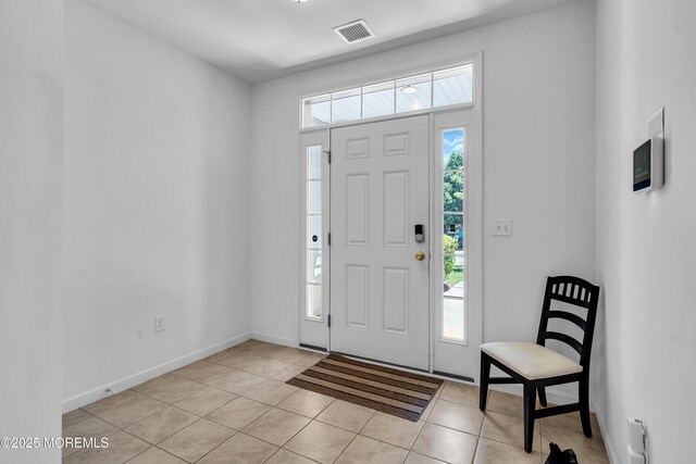 entryway featuring light tile patterned floors and baseboards