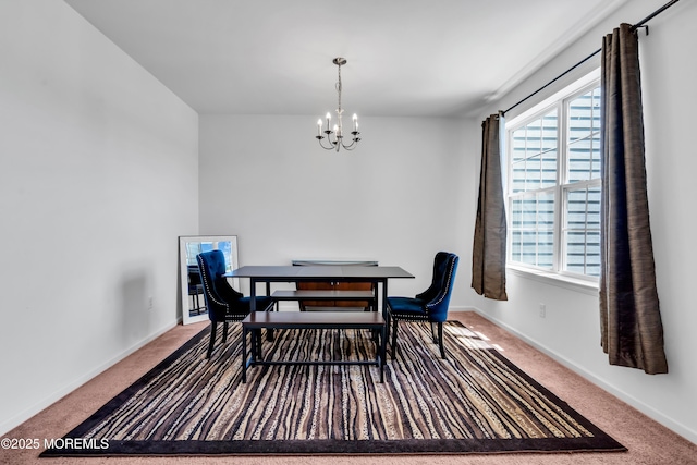 dining room featuring carpet floors, a chandelier, and baseboards