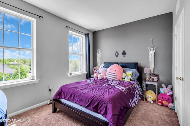 bedroom with carpet floors and baseboards
