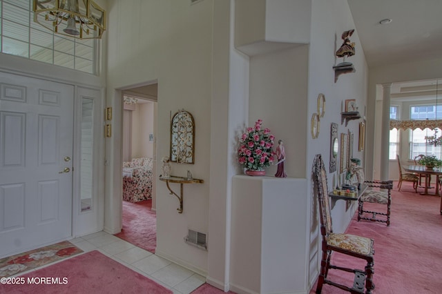 10 Lakeland Dr, Barnegat, NJ 08005 - foyer entrance featuring light colored carpet, a chandelier, light tile patterned flooring, and a towering ceiling