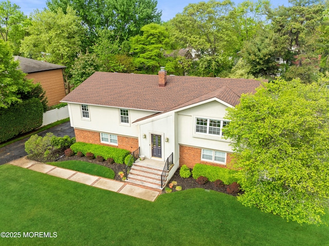 9 Darien Dr, West Long Branch, NJ 07764 - view of front of home featuring a chimney, stucco siding, roof with shingles, and brick siding