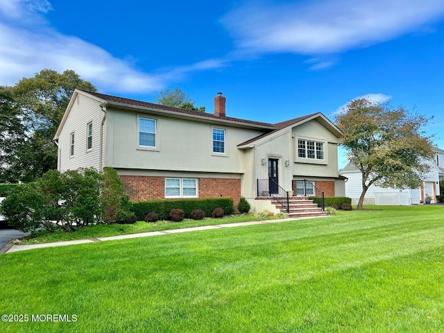 9 Darien Dr, West Long Branch, NJ 07764 - bi-level home featuring brick siding, a chimney, a front lawn, and stucco siding