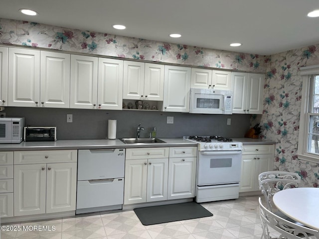 9 Darien Dr, West Long Branch, NJ 07764 - kitchen featuring white appliances, a sink, white cabinets, wallpapered walls, and recessed lighting