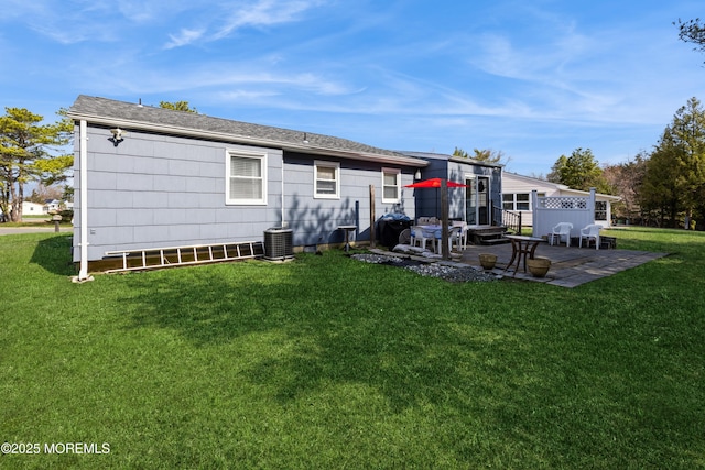 back of house with a patio area, a lawn, and central air condition unit