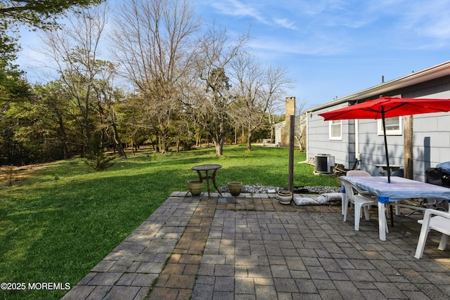 view of patio featuring central AC unit and outdoor dining space
