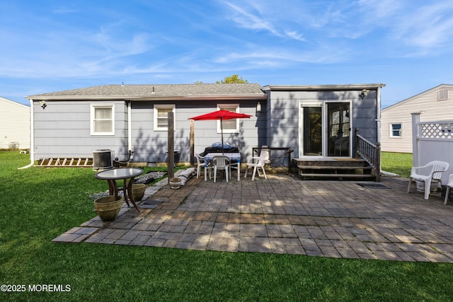back of property with a patio, a lawn, and cooling unit