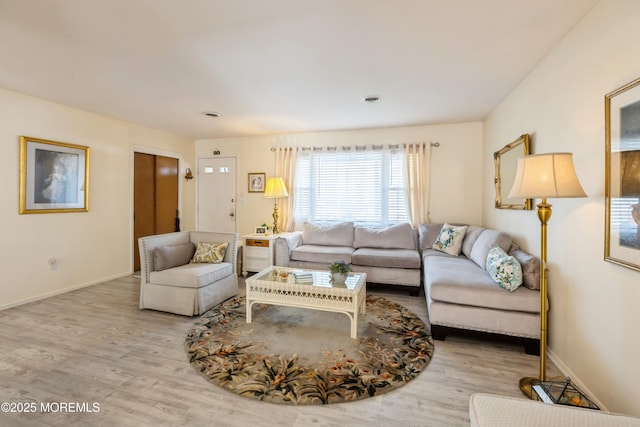 living room featuring wood finished floors and baseboards
