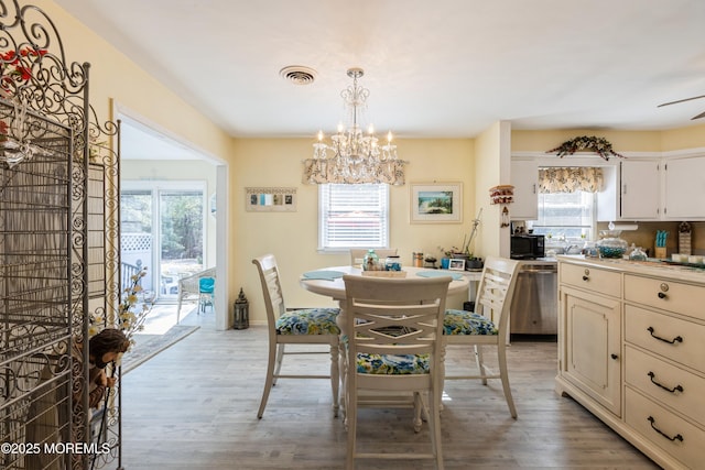 dining room featuring a chandelier and light wood-type flooring