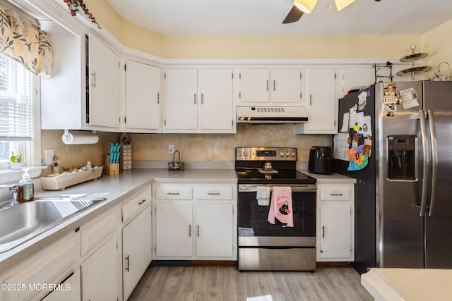 kitchen featuring stainless steel appliances, under cabinet range hood, light wood-style floors, a ceiling fan, and white cabinetry