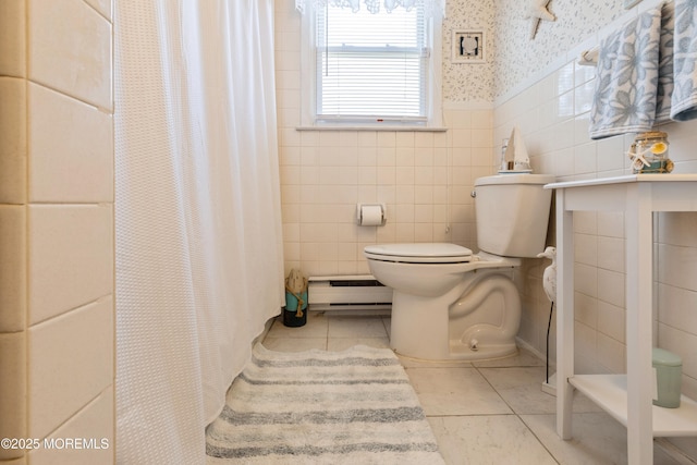 bathroom featuring tile walls, tile patterned floors, toilet, baseboard heating, and wallpapered walls
