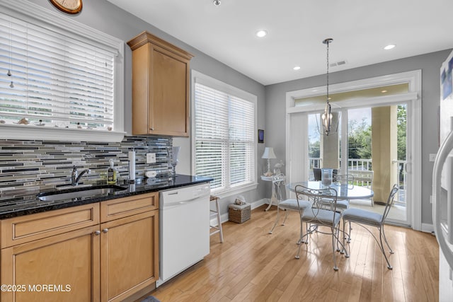 2210 Xanadu Ln, Wall, NJ 07719 - kitchen featuring white dishwasher, a sink, baseboards, tasteful backsplash, and dark stone counters