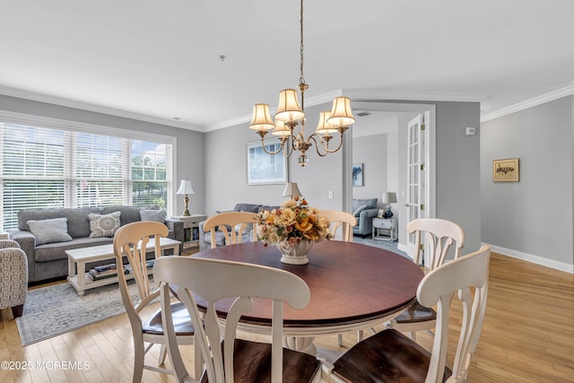2210 Xanadu Ln, Wall, NJ 07719 - dining room with light wood-type flooring, a chandelier, ornamental molding, and baseboards