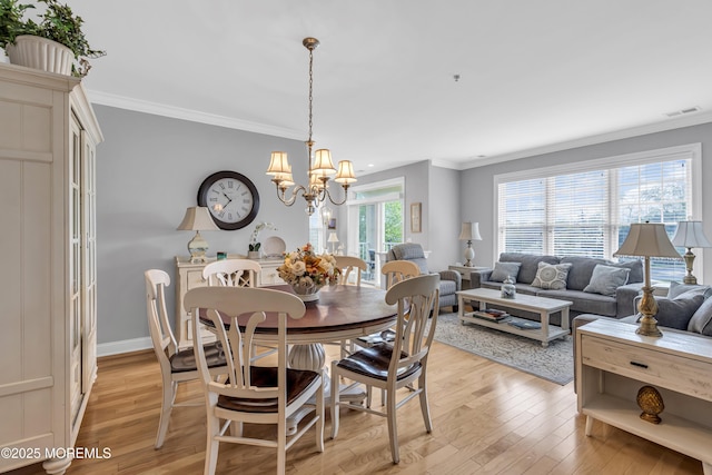 2210 Xanadu Ln, Wall, NJ 07719 - dining area with ornamental molding, a chandelier, light wood-type flooring, and baseboards