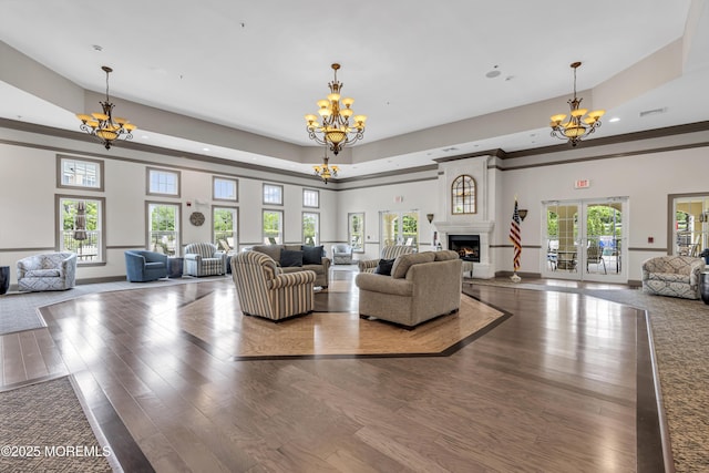 2210 Xanadu Ln, Wall, NJ 07719 - living room featuring a chandelier, wood finished floors, french doors, recessed lighting, and a lit fireplace