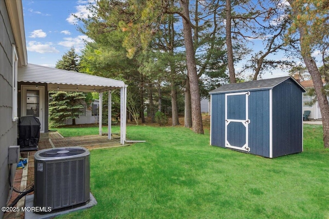 view of grassy yard featuring central air condition unit, a storage unit, and an outdoor structure