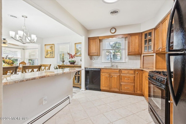 kitchen featuring black appliances, a chandelier, and brown cabinetry
