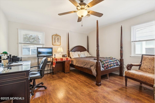 bedroom with a desk, wood finished floors, and a ceiling fan