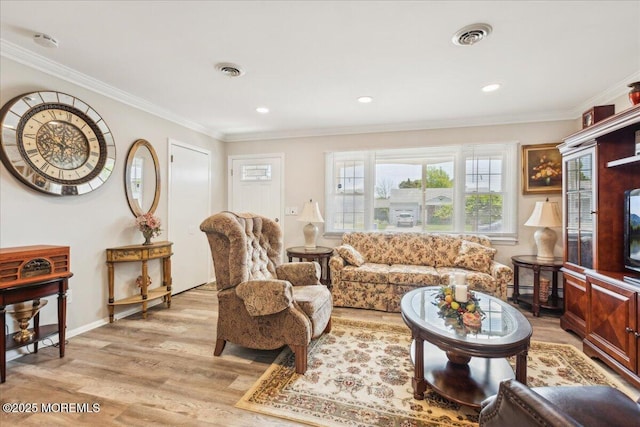 living area with light wood-style flooring, crown molding, baseboards, and recessed lighting