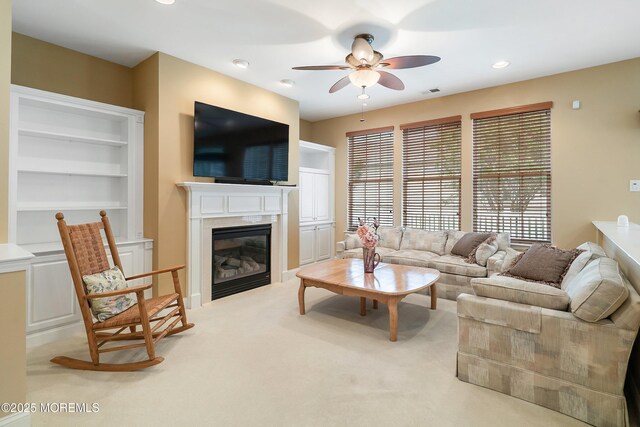 4 Augusta Dr, Little Egg Harbor, NJ 08087 - living area with ceiling fan, a glass covered fireplace, carpet, recessed lighting, and built in features