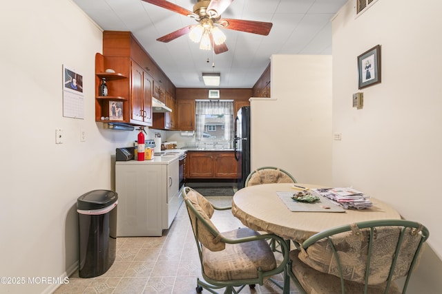 41D Cambridge Ct, Lakewood, NJ 08701 - kitchen featuring a ceiling fan, under cabinet range hood, freestanding refrigerator, light countertops, and brown cabinetry