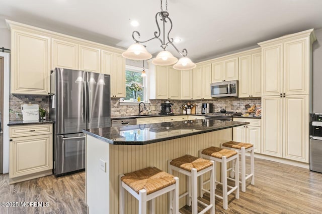 725 Province Line Rd, Allentown, NJ 08501 - kitchen featuring appliances with stainless steel finishes, cream cabinets, tasteful backsplash, and light wood-style flooring