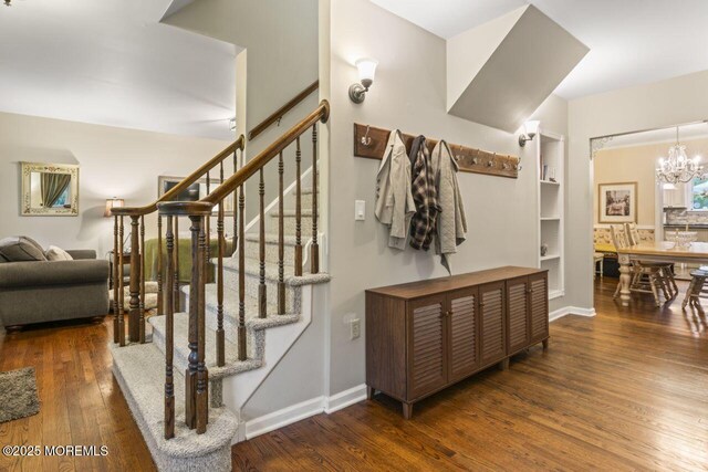 725 Province Line Rd, Allentown, NJ 08501 - stairs featuring hardwood / wood-style floors, a chandelier, baseboards, and built in features
