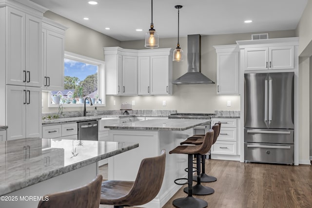 22 Ernest Dr, Lanoka Harbor, NJ 08734 - kitchen with stainless steel appliances, wall chimney range hood, a kitchen breakfast bar, recessed lighting, and white cabinetry