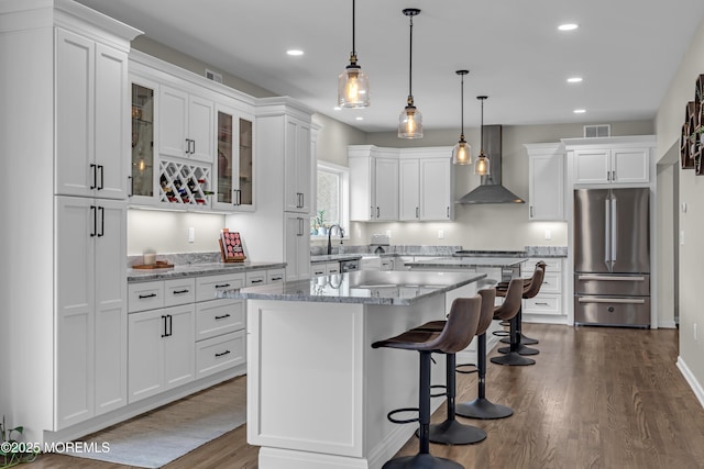 22 Ernest Dr, Lanoka Harbor, NJ 08734 - kitchen with freestanding refrigerator, wall chimney range hood, white cabinetry, recessed lighting, and a center island