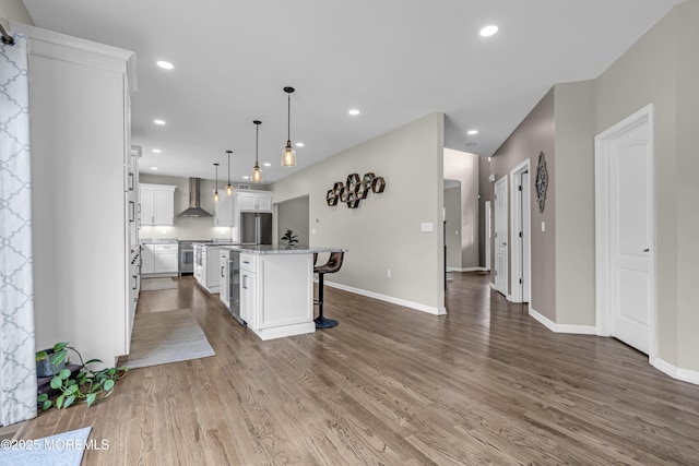 22 Ernest Dr, Lanoka Harbor, NJ 08734 - kitchen with wall chimney exhaust hood, stainless steel appliances, wood finished floors, white cabinetry, and baseboards