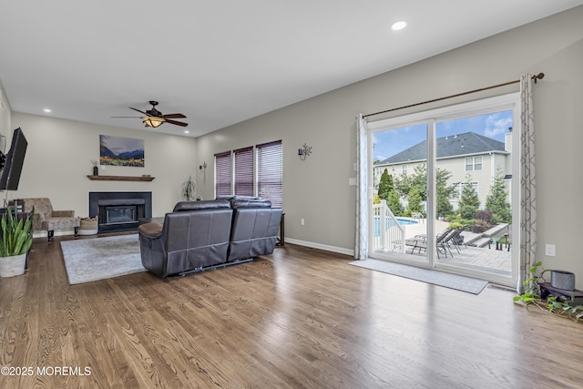 22 Ernest Dr, Lanoka Harbor, NJ 08734 - living room featuring wood finished floors, a ceiling fan, a glass covered fireplace, recessed lighting, and baseboards
