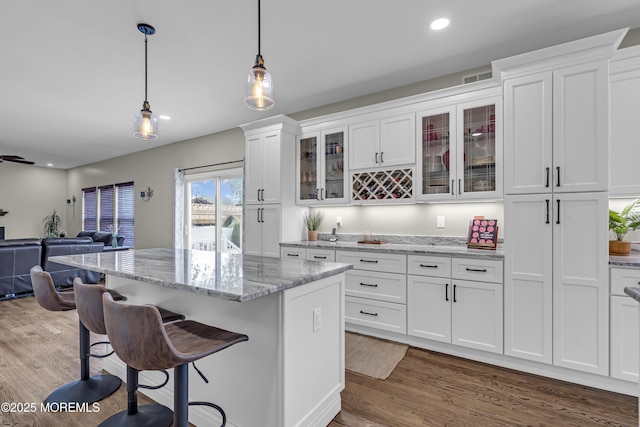 22 Ernest Dr, Lanoka Harbor, NJ 08734 - kitchen featuring white cabinets, a breakfast bar, wood finished floors, a kitchen island, and pendant lighting