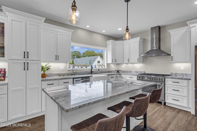 22 Ernest Dr, Lanoka Harbor, NJ 08734 - kitchen with appliances with stainless steel finishes, wall chimney range hood, a sink, a breakfast bar, and white cabinets