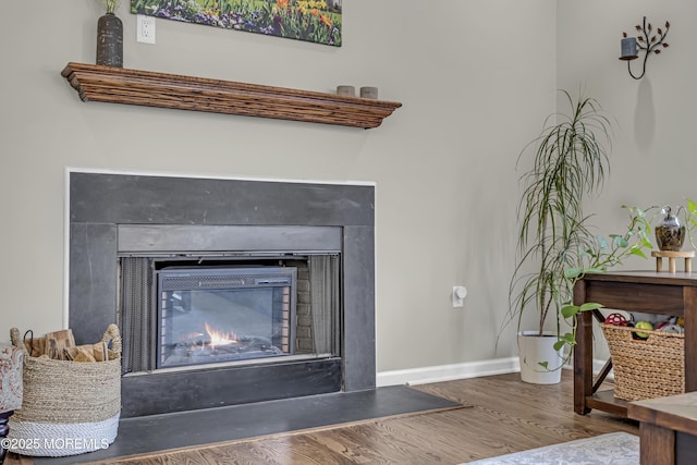 22 Ernest Dr, Lanoka Harbor, NJ 08734 - detailed view of a glass covered fireplace, wood finished floors, and baseboards