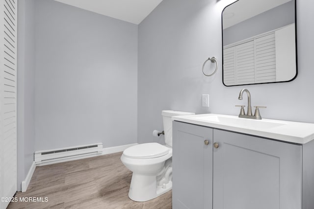 4B Greenwood Ln, Whiting, NJ 08759 - bathroom with a baseboard heating unit, toilet, baseboards, vanity, and wood finished floors